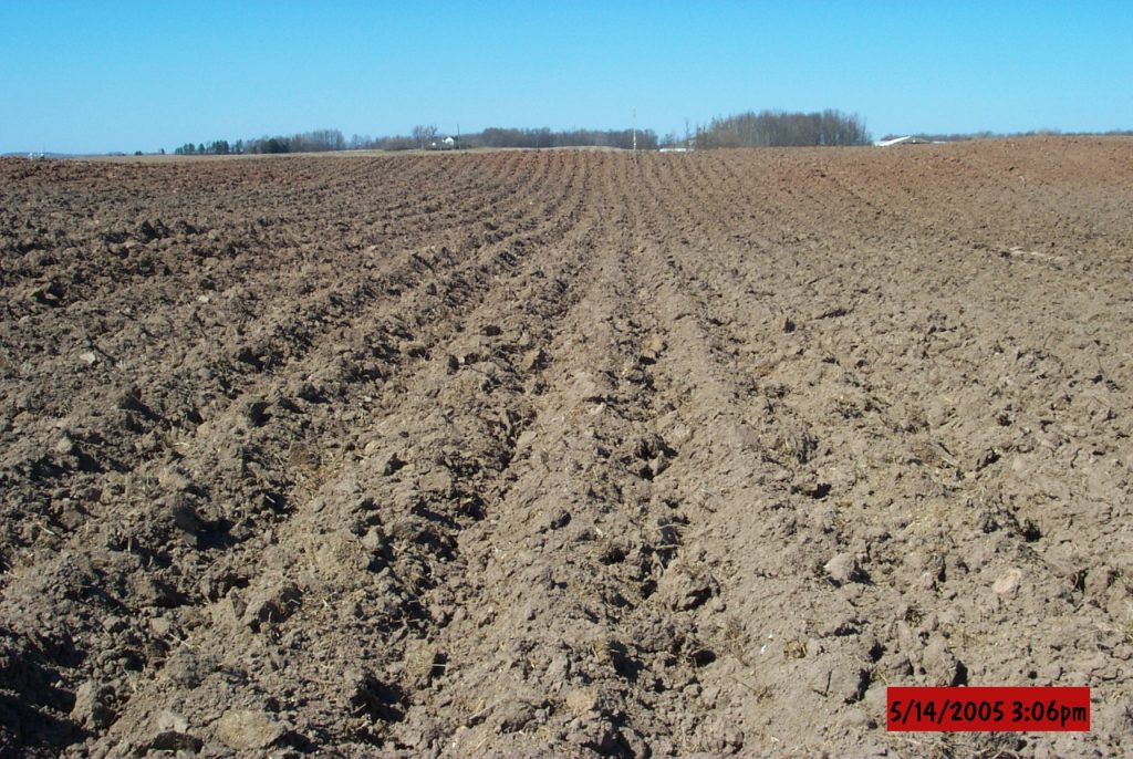 A farm field with soil that's been tilled.